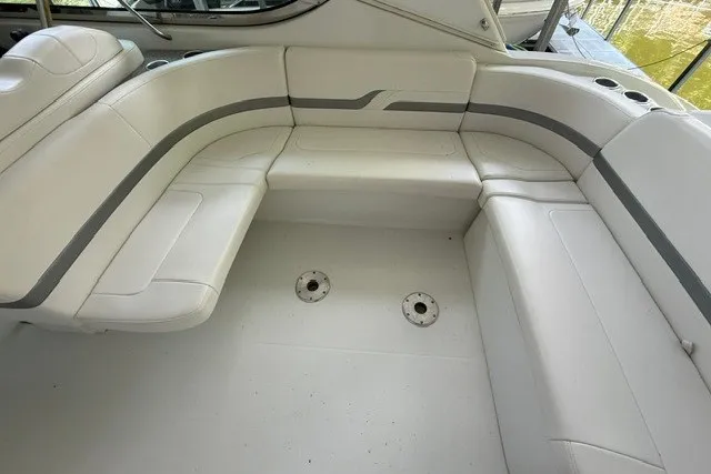 Slide: The Image of 2005 Formula 370 Super Sport boat interior with white leather seating and cup holders. - 19