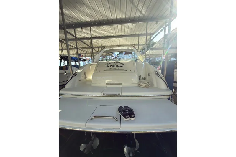 Slide: The Image of 2005 Formula 370 Super Sport boat docked under a metal canopy. - 27