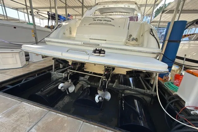 Slide: The Image of 2005 Formula 370 Super Sport boat docked, showcasing dual propellers and sleek design. - 28