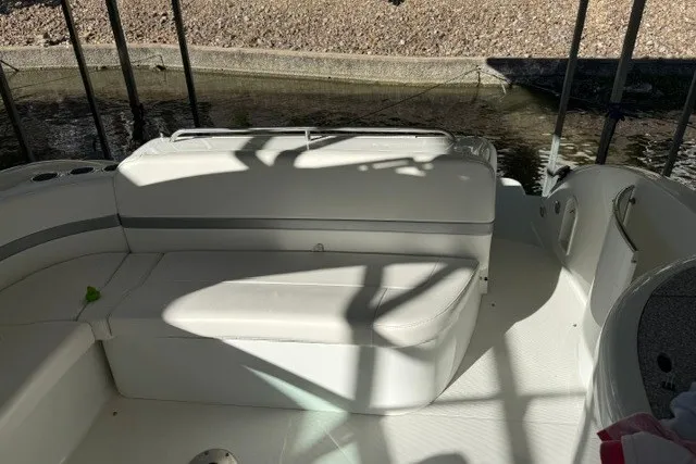 Slide: The Image of 2005 Formula 370 Super Sport boat interior with white seating and shaded deck area. - 31