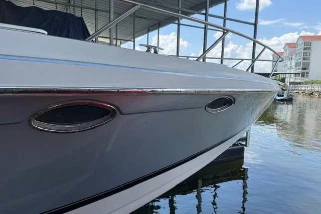 Slide: The Image of 2005 Formula 370 Super Sport boat docked at marina under clear sky. - 21