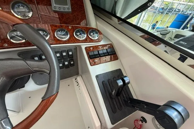 Slide: The Image of Dashboard of a 2005 Formula 370 Super Sport boat with steering wheel and controls. - 16