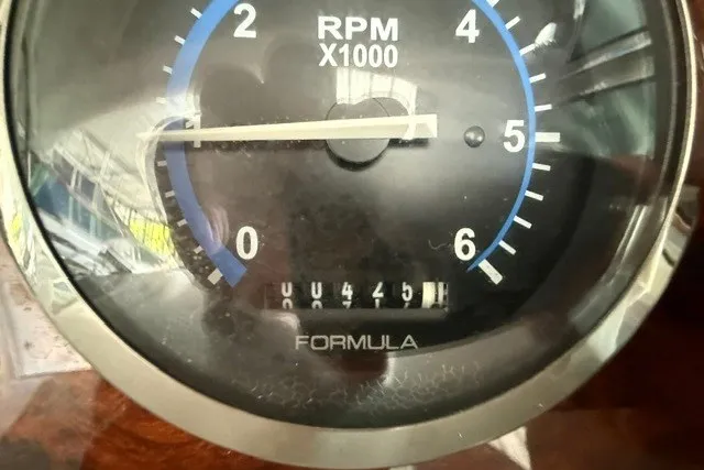 Slide: The Image of Close-up of a 2005 Formula 370 Super Sport RPM gauge displaying 445 hours. - 7