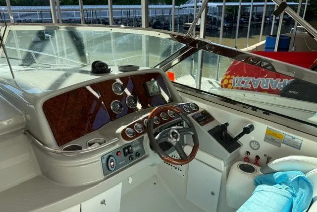 Slide: The Image of 2005 Formula 370 Super Sport boat dashboard with steering wheel and gauges. - 38