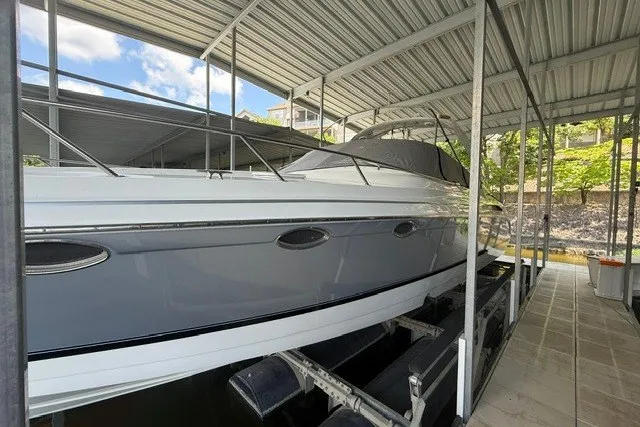 Slide: The Image of 2005 Formula 370 Super Sport boat docked under a metal canopy. - 3