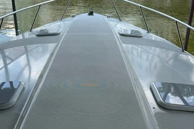 Slide: The Image of 2005 Formula 370 Super Sport boat deck with sleek design on calm water. - 14