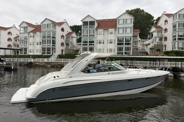 The Image of 2005 Formula 370 Super Sport boat docked near waterfront condos. - 0