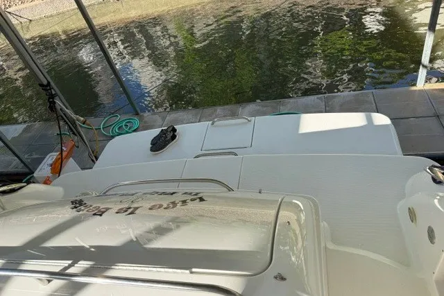 Slide: The Image of 2005 Formula 370 Super Sport boat docked by a calm waterway. - 30