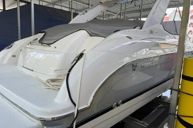 Slide: The Image of 2005 Formula 370 Super Sport boat docked under a covered marina. - 24