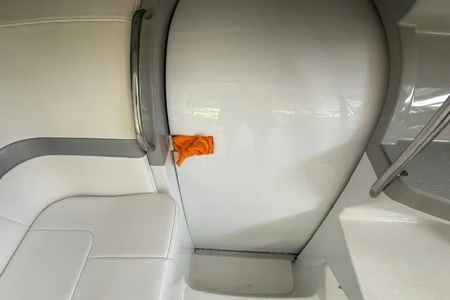 Slide: The Image of Interior of a 2005 Formula 370 Super Sport boat with white seating and orange cloth. - 12