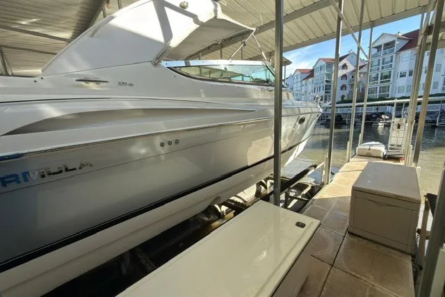 Slide: The Image of 2005 Formula 370 Super Sport boat docked in a marina with waterfront buildings. - 29