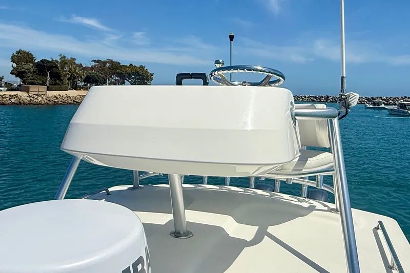 Slide: The Image of 2022 Parker 2520 XLD Sport Cabin boat helm with ocean backdrop. - 27