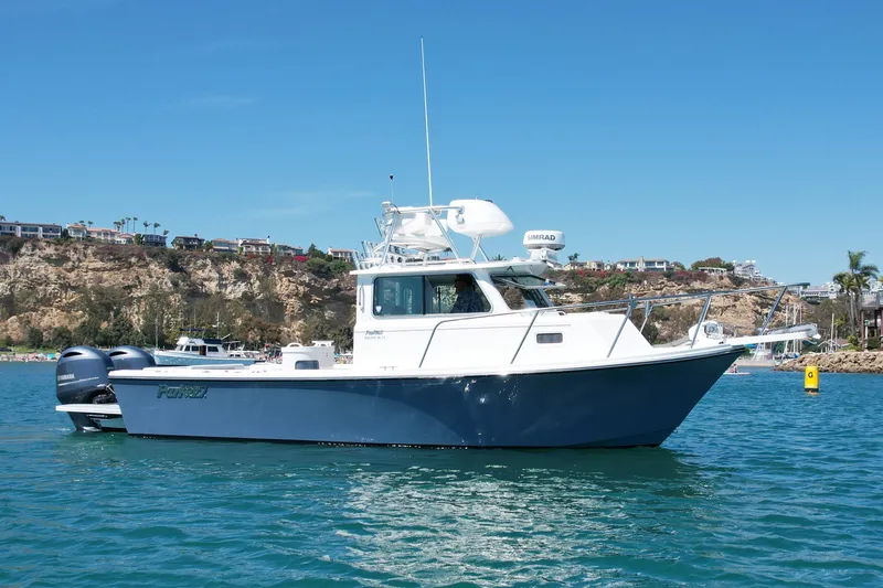 Slide: The Image of 2022 Parker 2520 XLD Sport Cabin boat on clear blue water. - 8