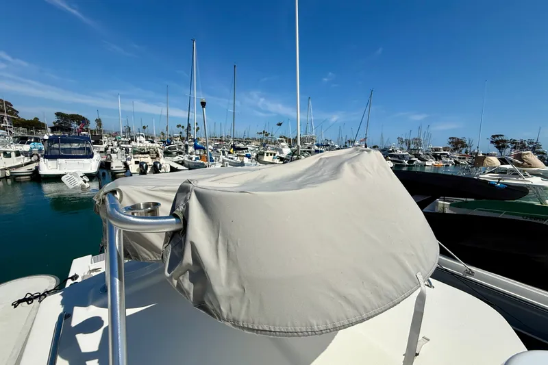 Slide: The Image of 2022 Parker 2520 XLD Sport Cabin boat docked in a marina under clear blue skies. - 44