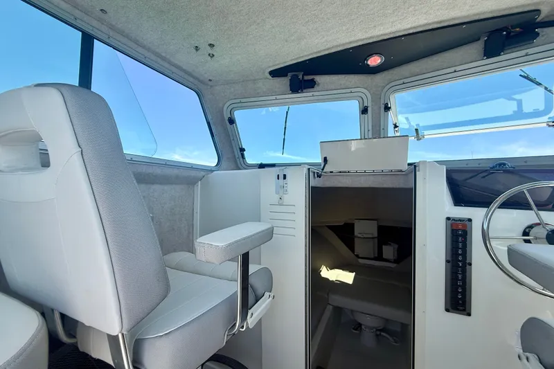 Slide: The Image of Interior of 2022 Parker 2520 XLD Sport Cabin with helm and seating. - 40