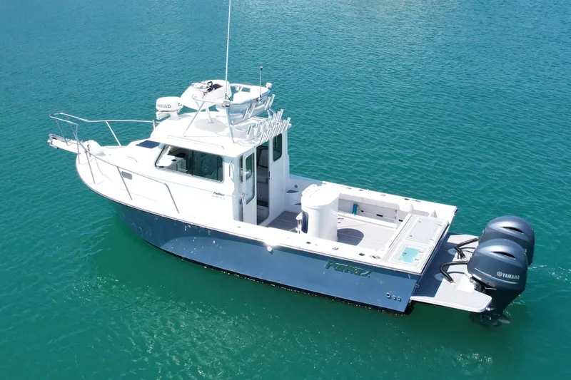 Slide: The Image of 2022 Parker 2520 XLD Sport Cabin boat on clear blue water, featuring dual Yamaha engines. - 4