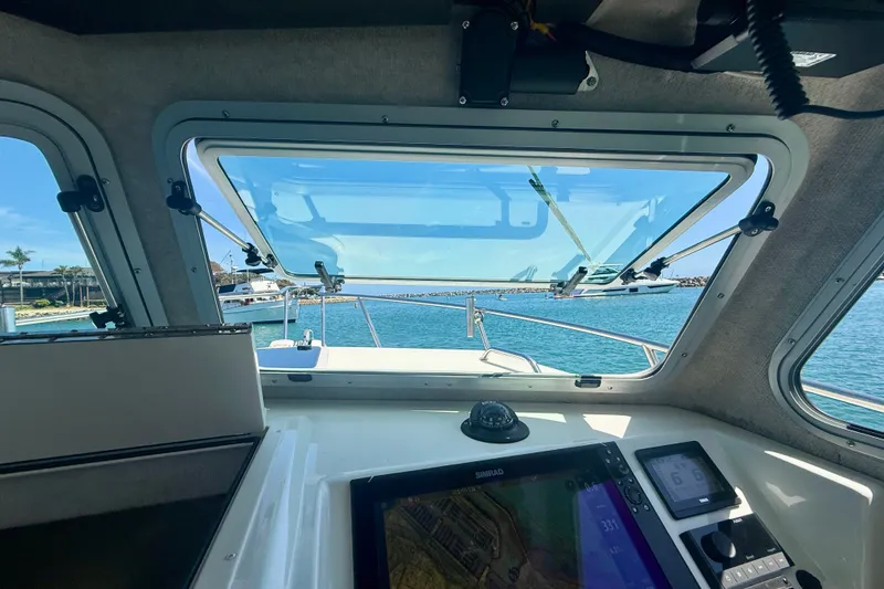 Slide: The Image of Interior view of 2022 Parker 2520 XLD Sport Cabin boat with navigation equipment. - 38