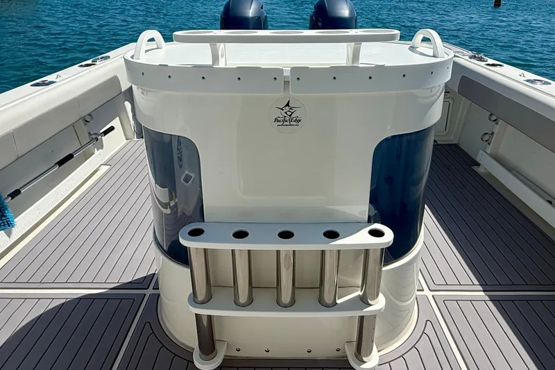 Slide: The Image of 2022 Parker 2520 XLD Sport Cabin boat deck with rod holders and ocean backdrop. - 32