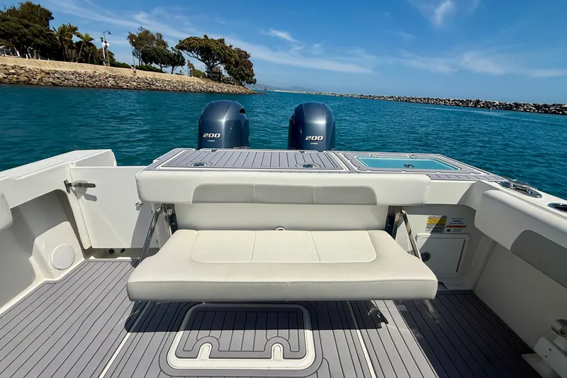 Slide: The Image of 2022 Parker 2520 XLD Sport Cabin boat with twin engines on a sunny day. - 22