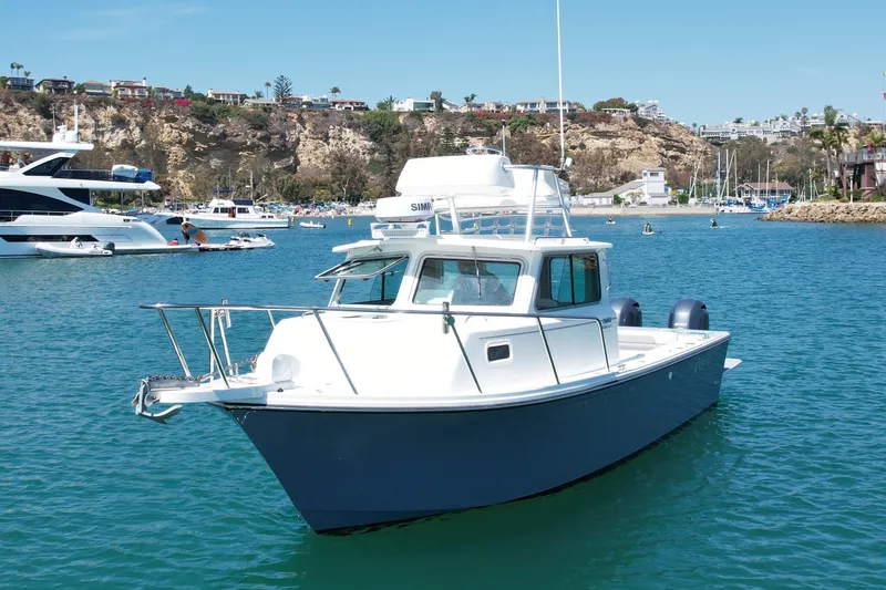 Slide: The Image of 2022 Parker 2520 XLD Sport Cabin boat in scenic harbor setting. - 3