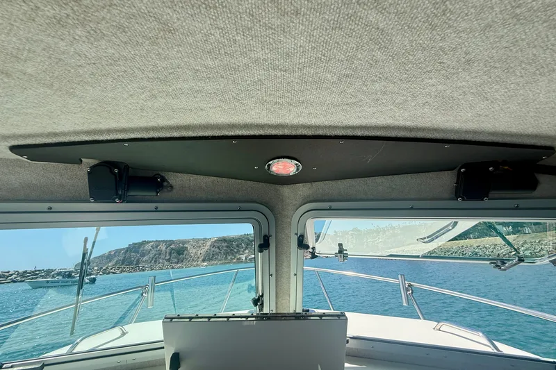 Slide: The Image of Interior view from a 2022 Parker 2520 XLD Sport Cabin boat, overlooking the ocean. - 15