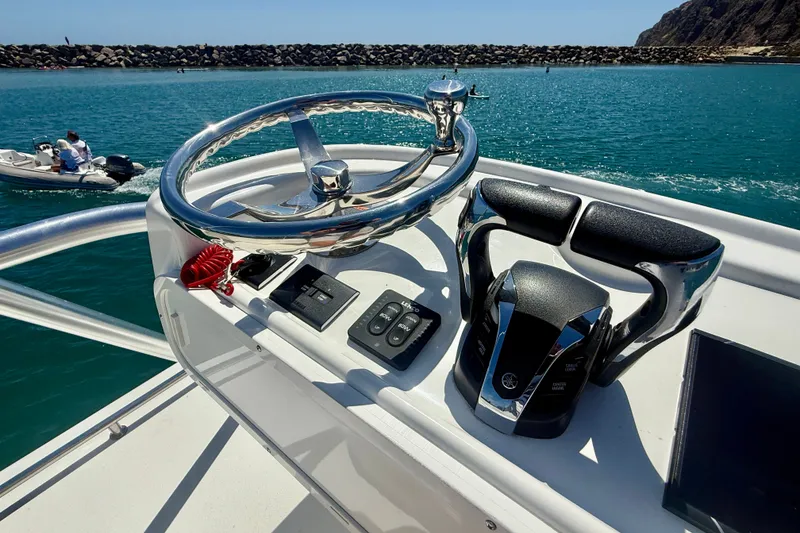 Slide: The Image of Helm of 2022 Parker 2520 XLD Sport Cabin boat with steering wheel and controls. - 31