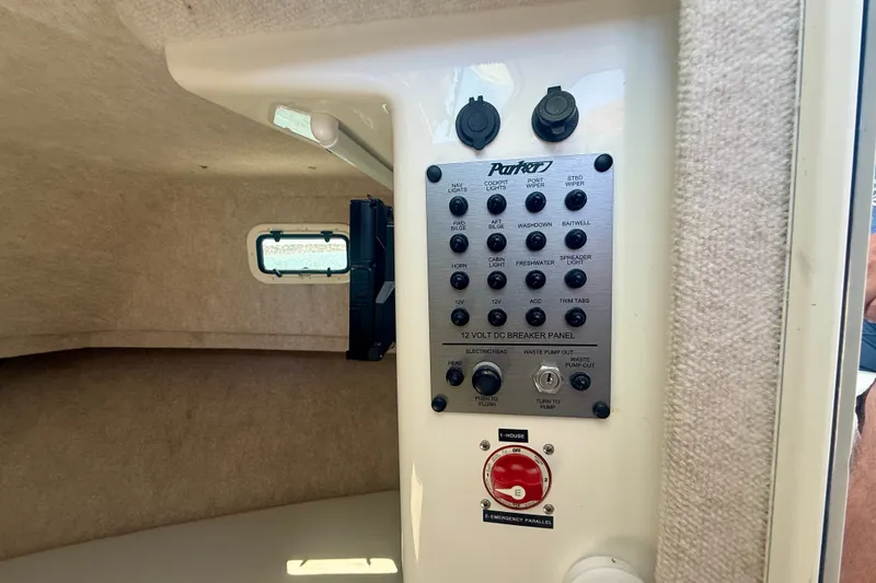 Slide: The Image of Control panel inside 2022 Parker 2520 XLD Sport Cabin boat, featuring various switches and outlets. - 12