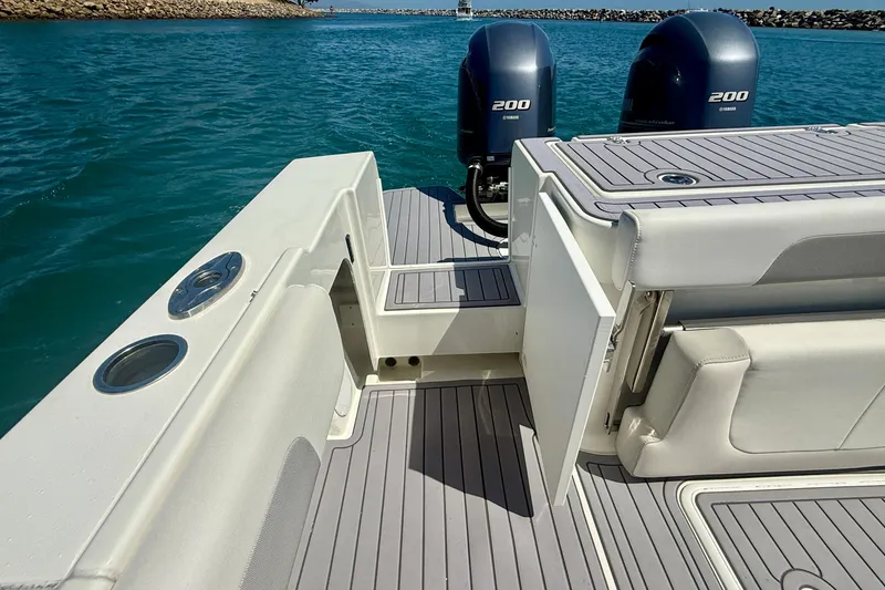 Slide: The Image of 2022 Parker 2520 XLD Sport Cabin boat with twin Yamaha 200 engines on blue water. - 24
