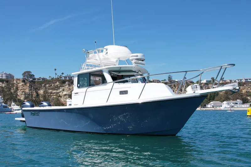 Slide: The Image of 2022 Parker 2520 XLD Sport Cabin boat on clear blue water. - 9