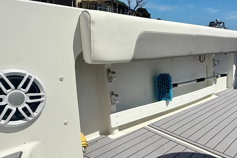 Slide: The Image of 2022 Parker 2520 XLD Sport Cabin boat interior with speaker and cleaning brush. - 34