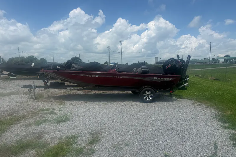The Image of 2018 Ranger RT188 boat on trailer, parked on gravel under a cloudy sky. - 1