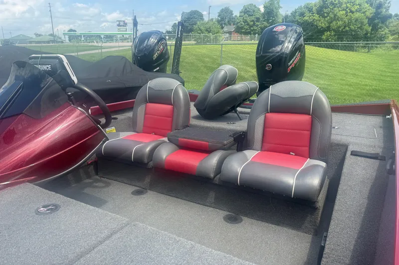 Slide: The Image of 2018 Ranger RT188 boat interior with red and gray seating, steering wheel, and motor. - 11