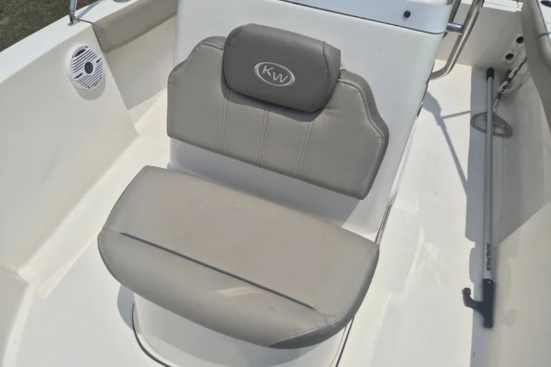 Slide: The Image of 2024 Key West 179 FS boat seat with gray upholstery and KW logo. - 16