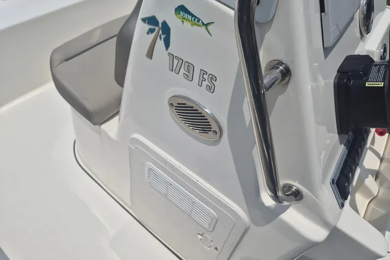Slide: The Image of 2024 Key West 179 FS boat console with speaker and seating detail. - 13