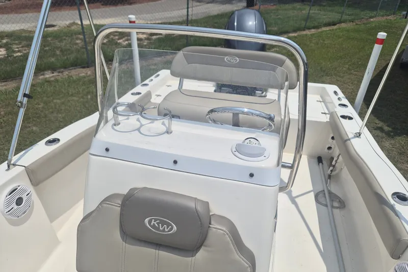 Slide: The Image of 2024 Key West 179 FS boat interior with steering console and seating. - 17