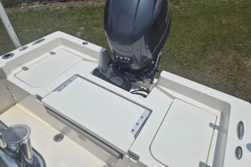 Slide: The Image of 2024 Key West 179 FS boat with Yamaha 115 engine, white deck, and storage compartments. - 5