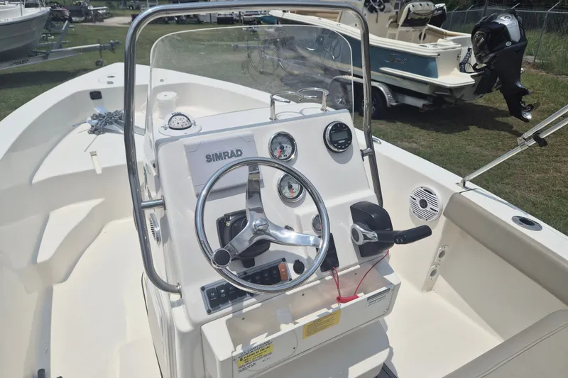 Slide: The Image of 2024 Key West 179 FS boat dashboard with steering wheel and controls. - 10