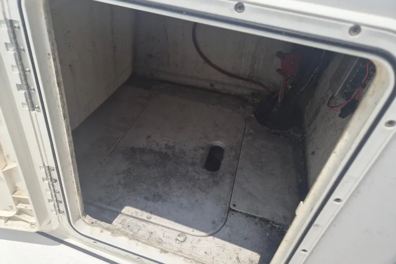 Slide: The Image of Open storage compartment in 2024 Key West 179 FS boat, showing interior details. - 14