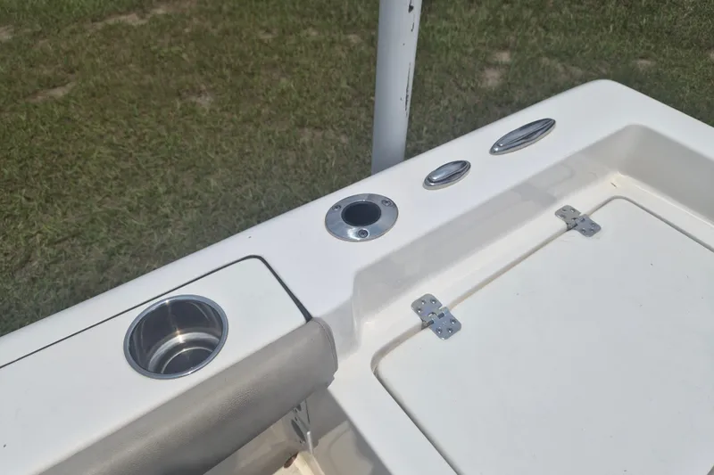 Slide: The Image of 2024 Key West 179 FS boat deck with cup holder and storage compartment. - 7