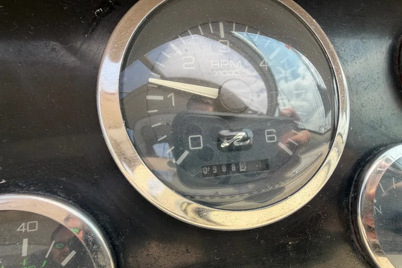 Slide: The Image of Close-up of a 1999 Sea Ray Sundancer 330 RPM gauge showing 988.9 hours. - 21