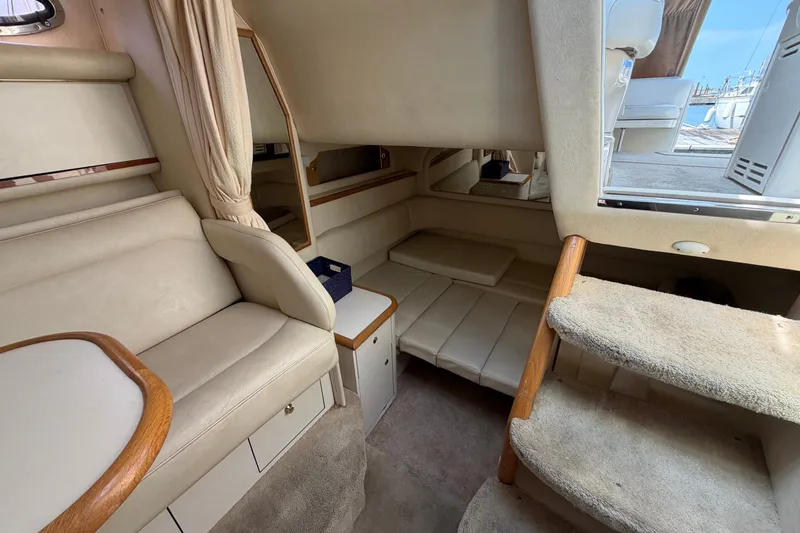Slide: The Image of Interior of 1999 Sea Ray Sundancer 330 yacht with beige seating and carpeted stairs. - 30