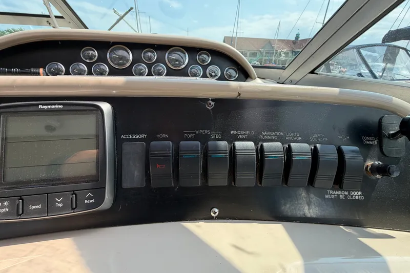 Slide: The Image of Control panel of a 1999 Sea Ray Sundancer 330 boat with switches and gauges. - 20