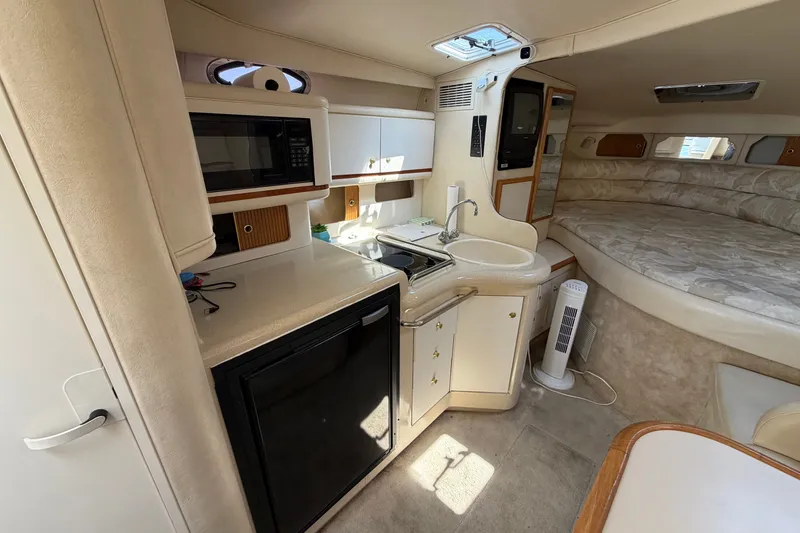 Slide: The Image of Interior of 1999 Sea Ray Sundancer 330 yacht with kitchenette and sleeping area. - 25