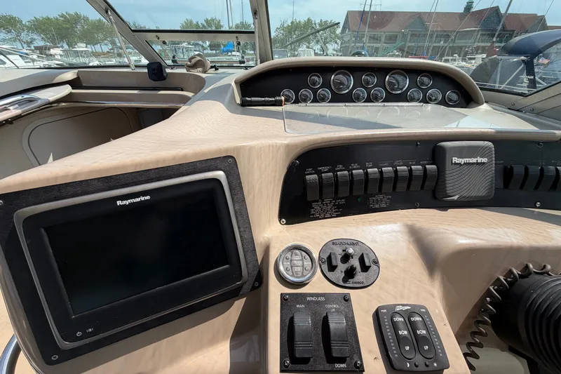 Slide: The Image of 1999 Sea Ray Sundancer 330 helm with Raymarine electronics and control panel. - 18