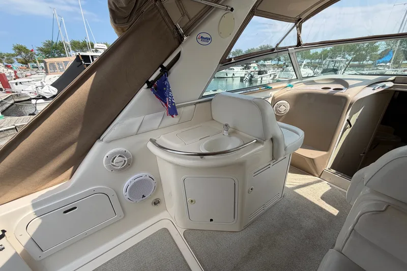 Slide: The Image of Interior of a 1999 Sea Ray Sundancer 330 yacht, featuring a compact sink and seating area. - 13