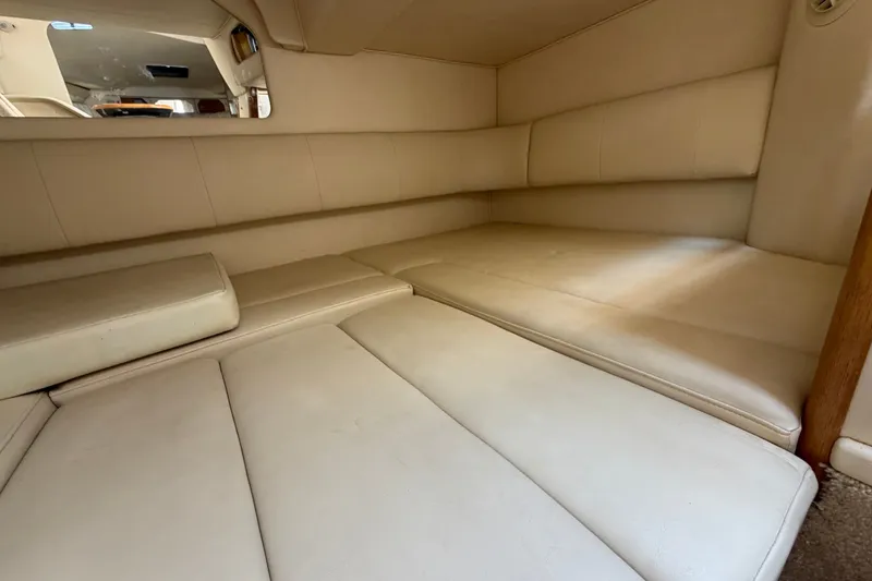 Slide: The Image of Interior cabin of 1999 Sea Ray Sundancer 330 with beige upholstery and spacious seating. - 34