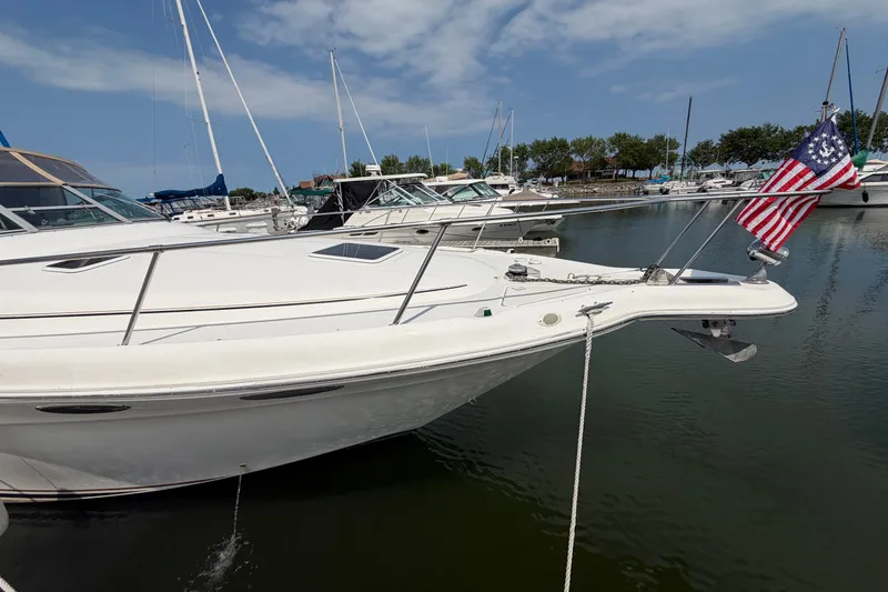 Slide: The Image of 1999 Sea Ray Sundancer 330 yacht docked in marina with American flag. - 6