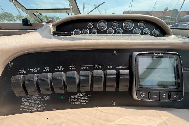 Slide: The Image of Control panel of a 1999 Sea Ray Sundancer 330 boat with switches and Raymarine display. - 19