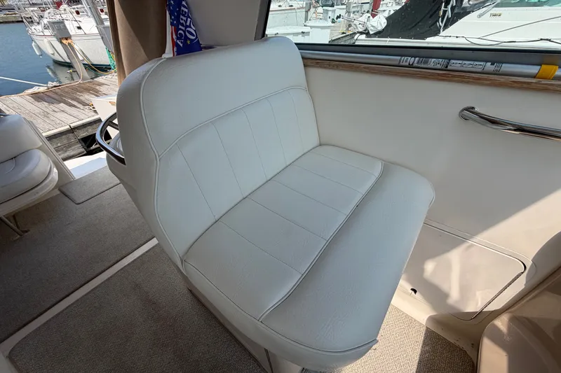 Slide: The Image of White leather seat on 1999 Sea Ray Sundancer 330 yacht, docked at marina. - 15