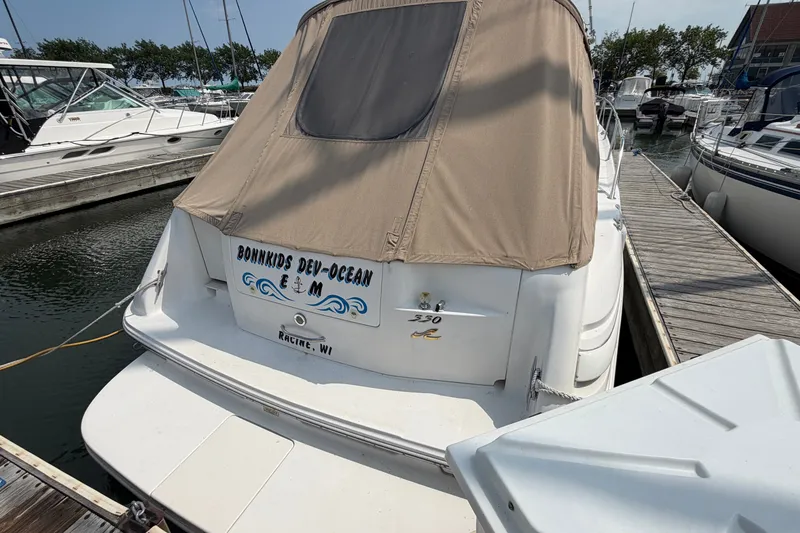 Slide: The Image of 1999 Sea Ray Sundancer 330 docked at marina, Racine, WI, with beige cover. - 4